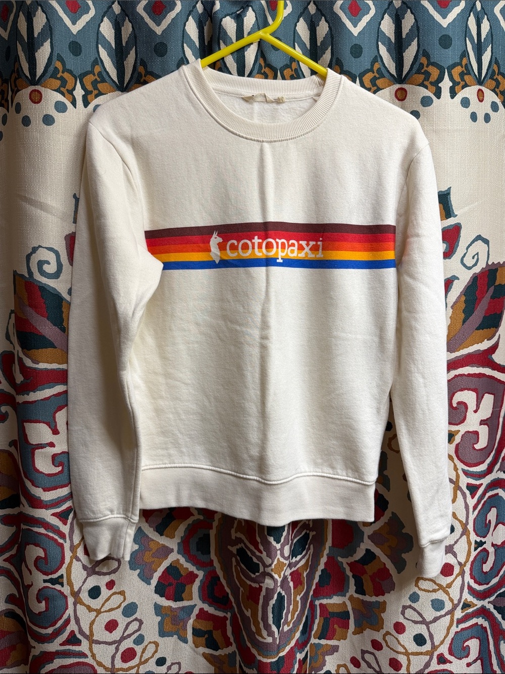 cotopaxi Cream Crewneck Sweatshirt with Red-Orange-Yellow-Blue Stripe